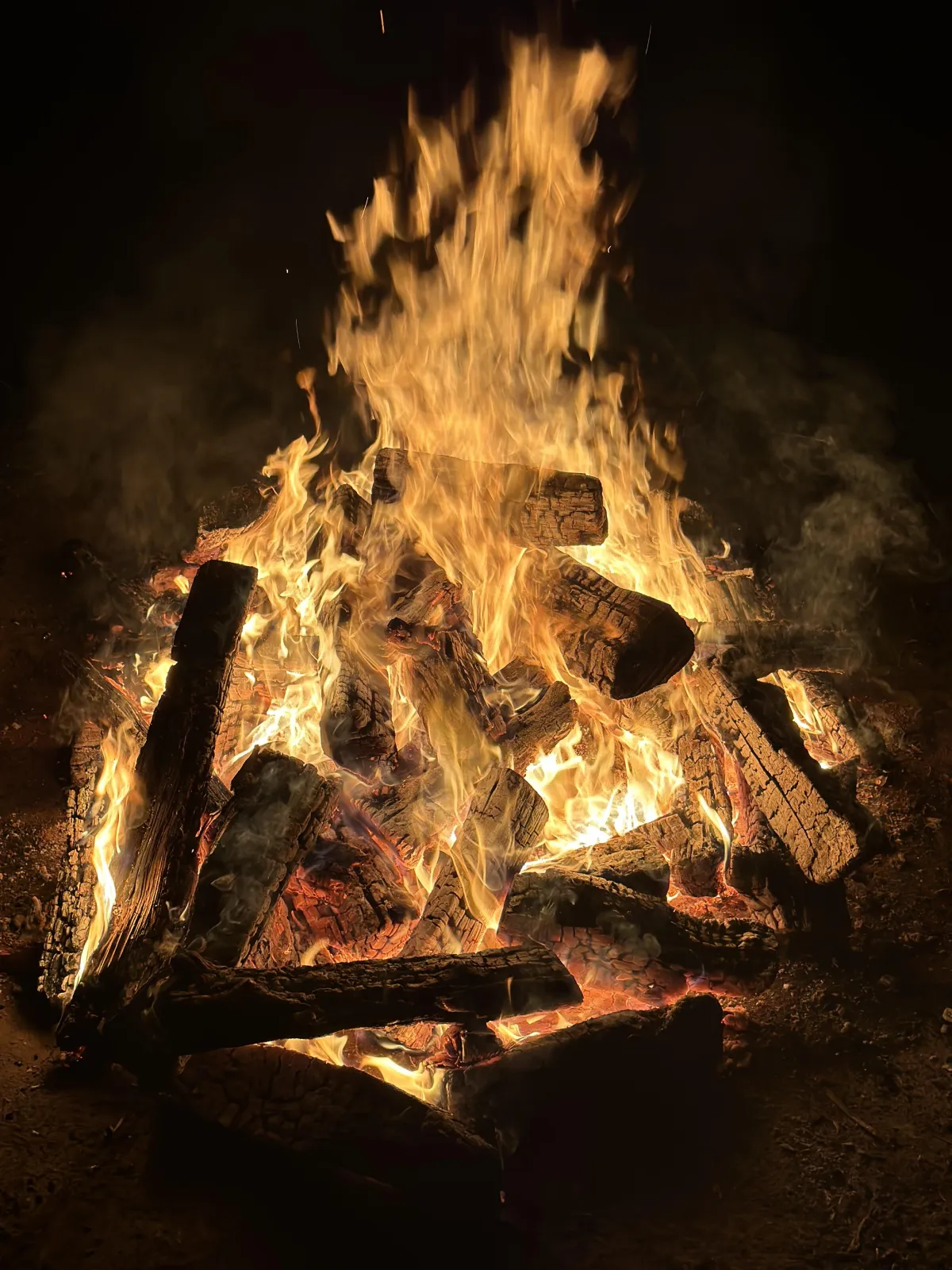 Flames rising from a prepared outdoor fire